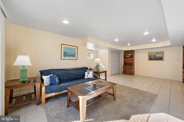 a living room with furniture a rug and a large window