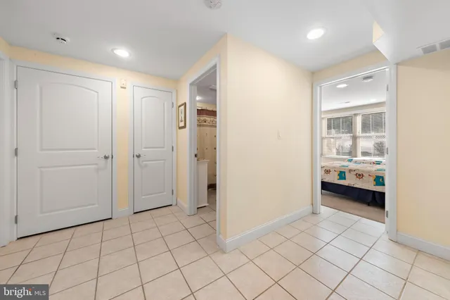 a living room with stainless steel appliances kitchen island granite countertop furniture and a chandelier