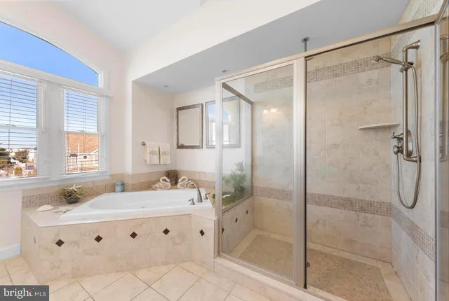 a spacious bedroom with a bed and couch