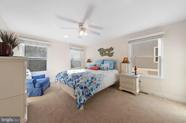 a bedroom with two beds and a window