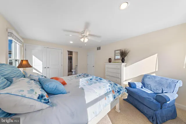 a bedroom with bed and cabinets