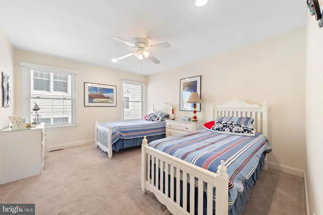 a bed room with a bed and a ceiling fan