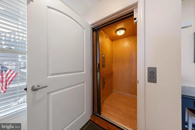 a view of a street with a house in the background