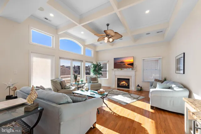 a kitchen with stainless steel appliances granite countertop a stove a sink and white cabinets with wooden floor