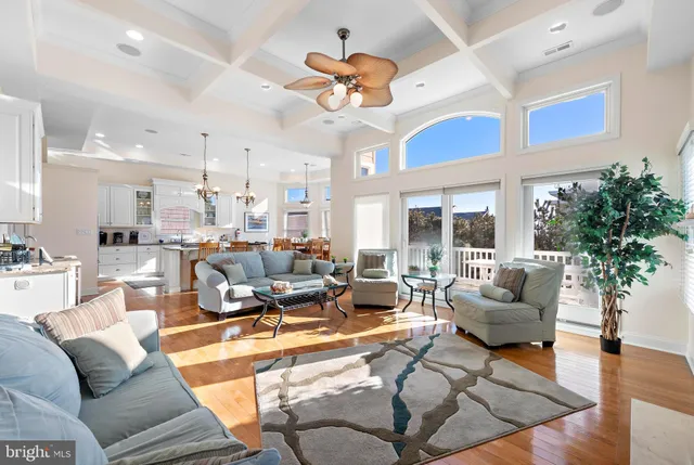 a living room with furniture kitchen and a large window