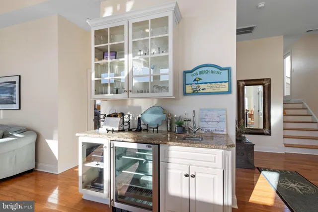 a kitchen with granite countertop stainless steel appliances a refrigerator a sink a stove a microwave and cabinets