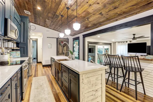 a open kitchen with stainless steel appliances granite countertop a stove and cabinets