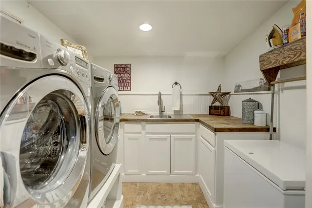 a kitchen with a sink a washer and dryer