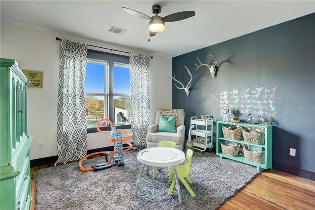 a living room with furniture a chandelier and a table