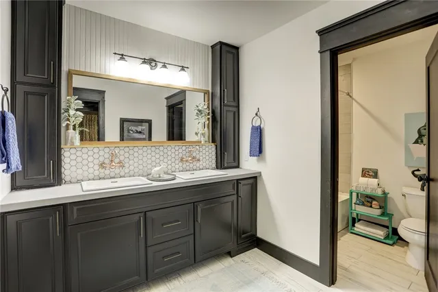 a bathroom with a double vanity sink and a mirror