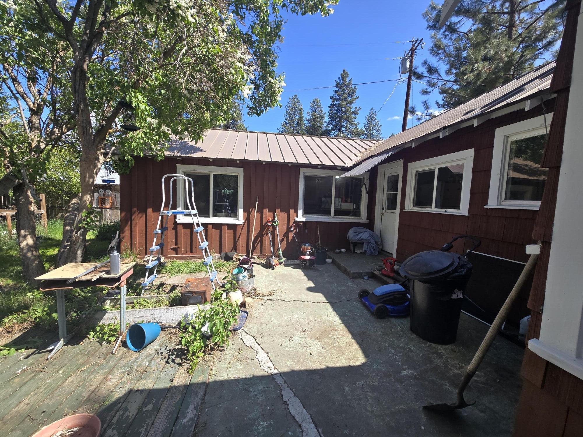 409 East Ash Street Chiloquin, OR 97624 - Photo 32 of 37 a view of a house with backyard sitting area and garden