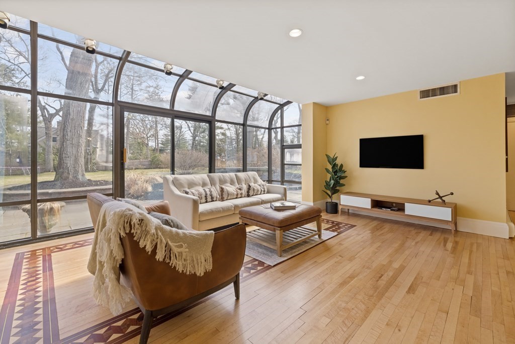 77 Hallwood Road Brookline, MA 02467 - Photo 11 of 42 a living room with furniture and a flat screen tv