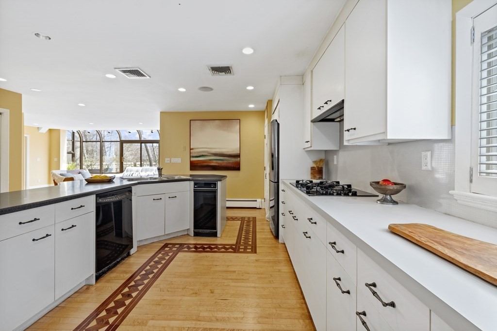 77 Hallwood Road Brookline, MA 02467 - Photo 15 of 42 a kitchen with a sink stove and cabinets