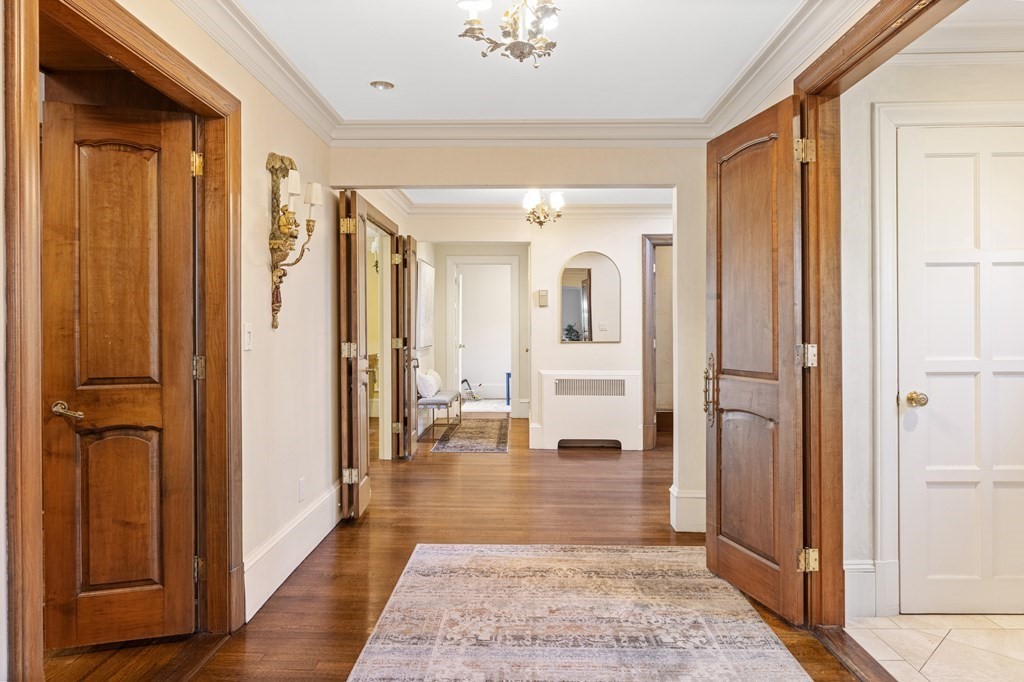 77 Hallwood Road Brookline, MA 02467 - Photo 17 of 42 a view of a hallway with wooden floor windows and a livingroom