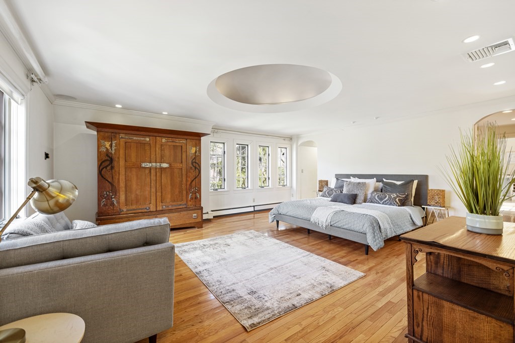 77 Hallwood Road Brookline, MA 02467 - Photo 25 of 42 a spacious bedroom with a bed and wooden floor