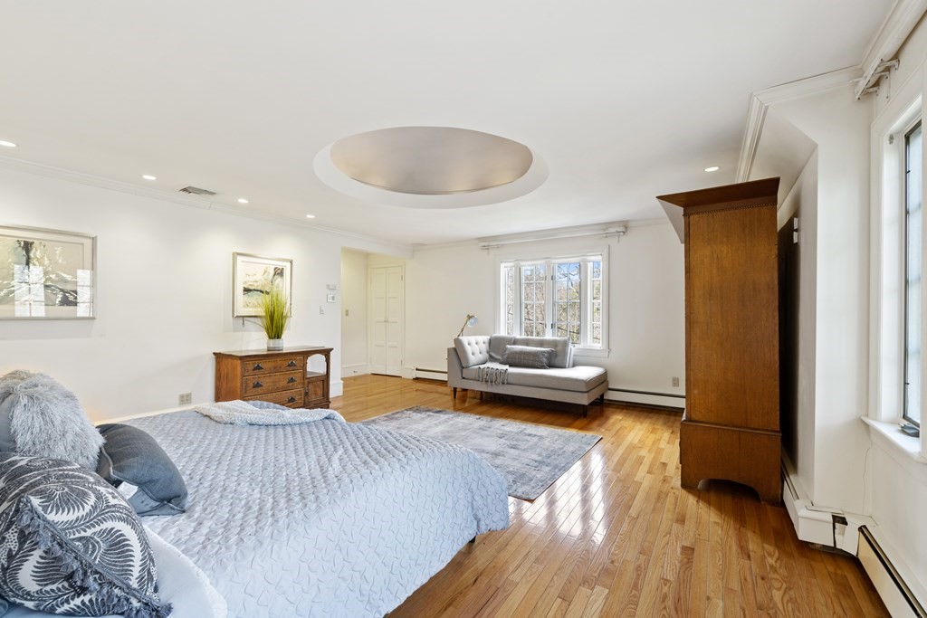 77 Hallwood Road Brookline, MA 02467 - Photo 26 of 42 a bedroom with a bed and a wooden floor