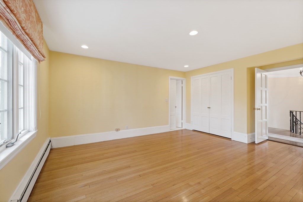 77 Hallwood Road Brookline, MA 02467 - Photo 31 of 42 a view of an empty room with wooden floor and a window