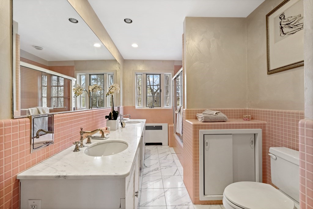 77 Hallwood Road Brookline, MA 02467 - Photo 32 of 42 a bathroom with a toilet sink and mirror