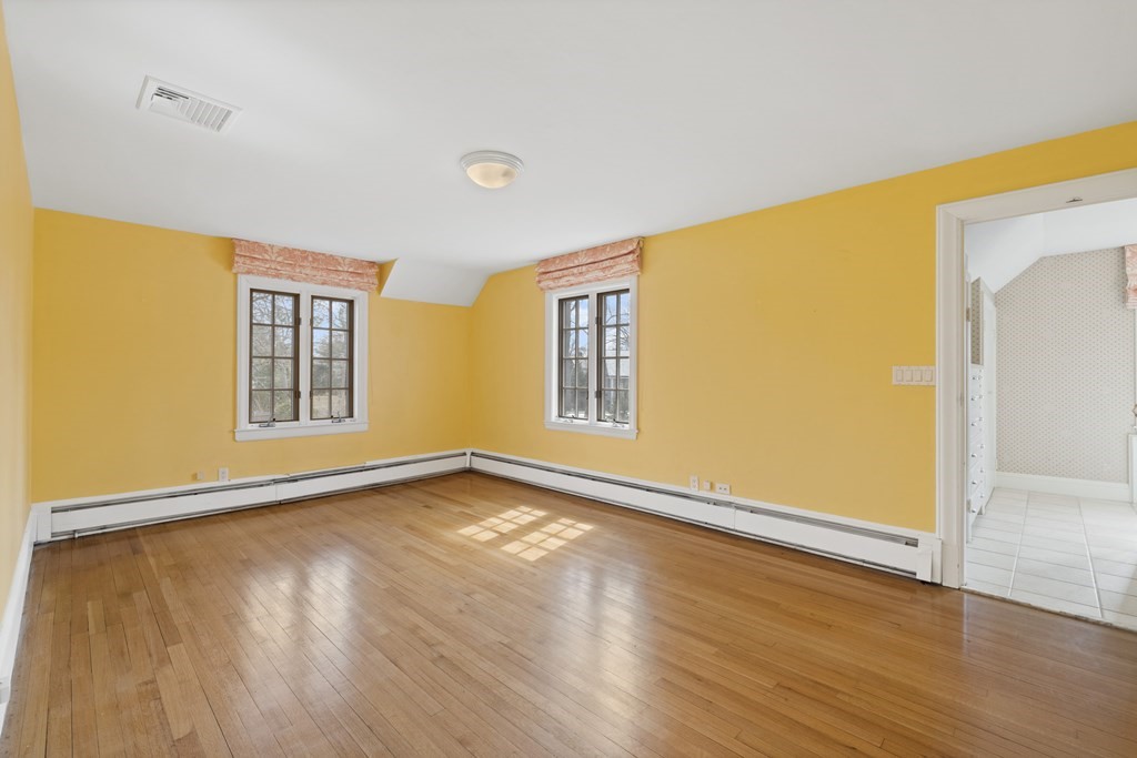 77 Hallwood Road Brookline, MA 02467 - Photo 33 of 42 a view of an empty room with wooden floor and a window