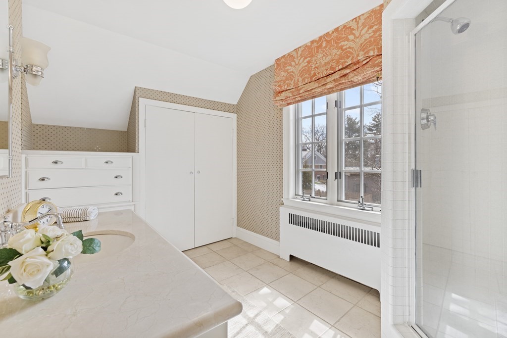 77 Hallwood Road Brookline, MA 02467 - Photo 34 of 42 a bathroom with a bathtub sink and mirror
