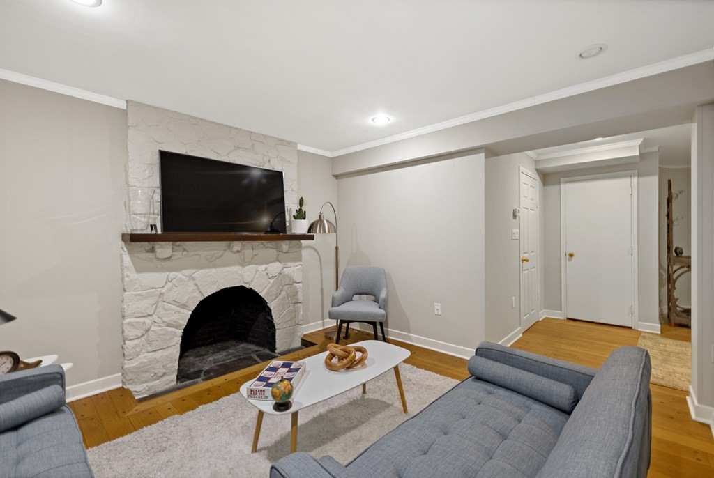 77 Hallwood Road Brookline, MA 02467 - Photo 37 of 42 a living room with furniture and a fireplace