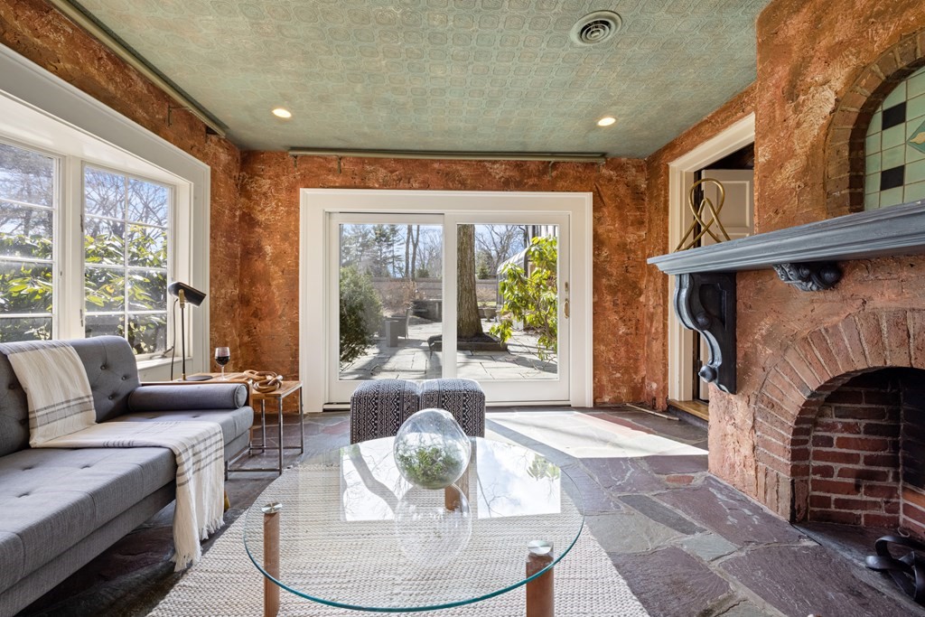 77 Hallwood Road Brookline, MA 02467 - Photo 6 of 42 a living room with furniture a fireplace and a table