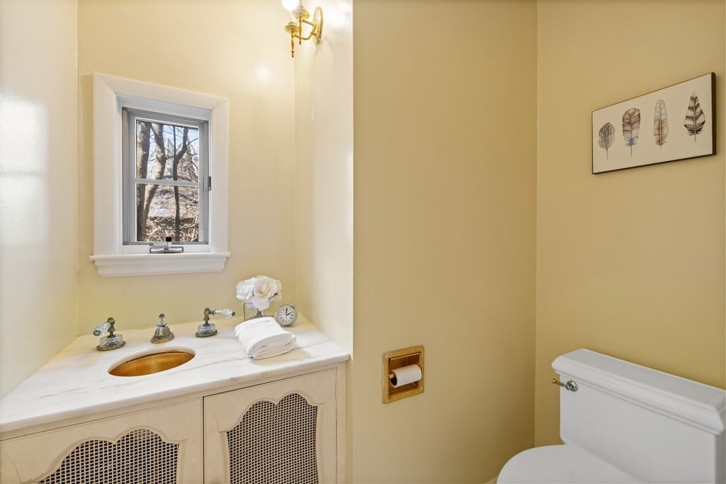 77 Hallwood Road Brookline, MA 02467 - Photo 8 of 42 a bathroom with a toilet sink and mirror