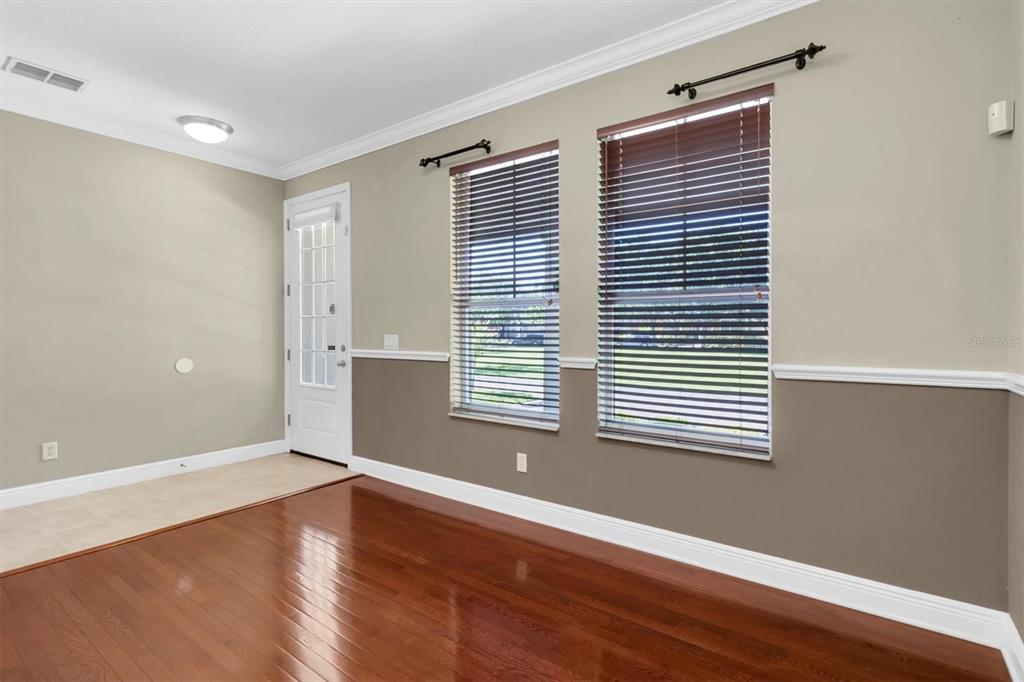 10121 Porch Street New Port Richey, FL 34655 - Photo 7 of 57 a view of an empty room with wooden floor and a window