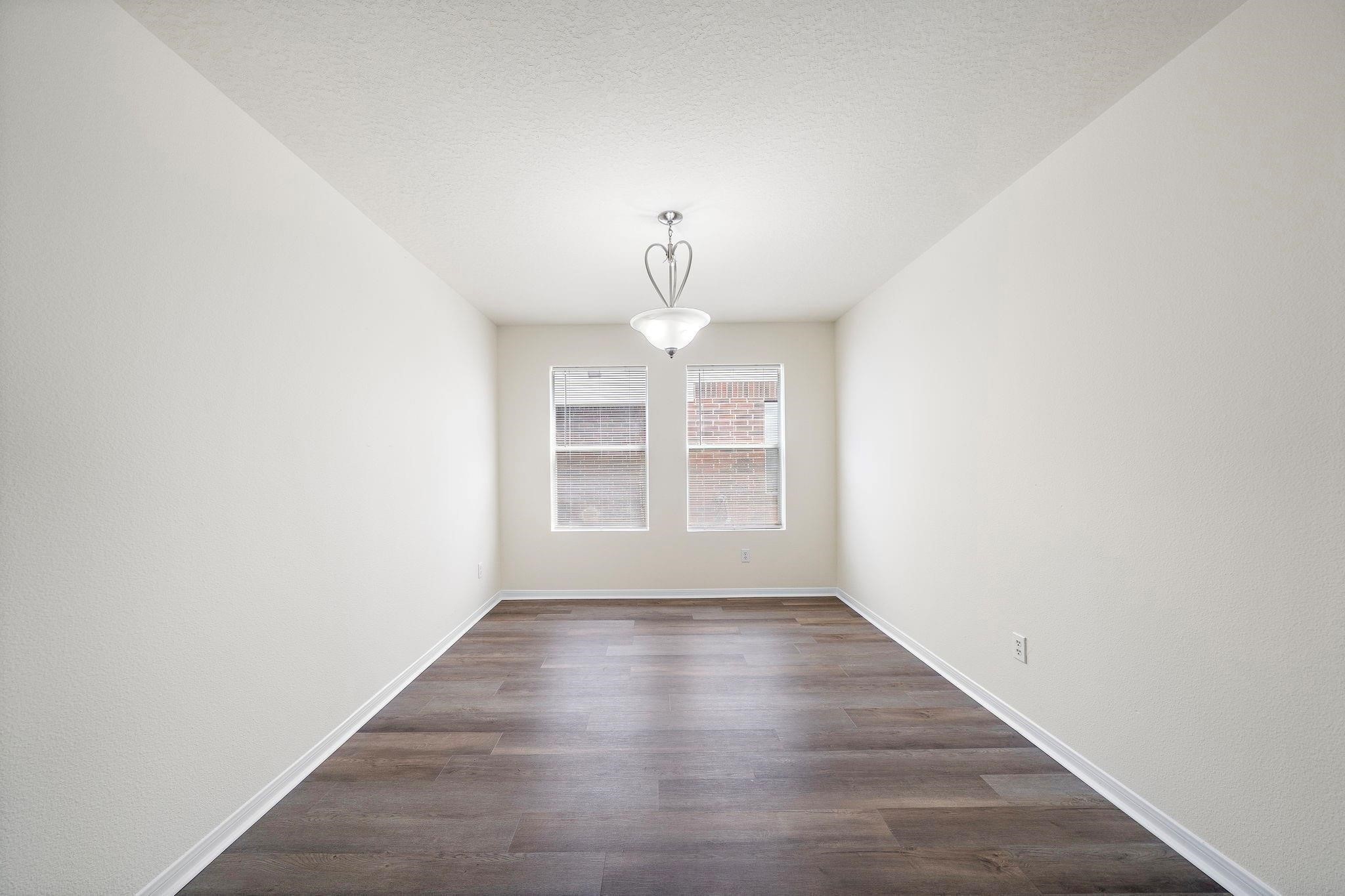 3235 Clipper Winds Way Houston, TX 77084 - Photo 11 of 26 a view of empty room with wooden floor and fan