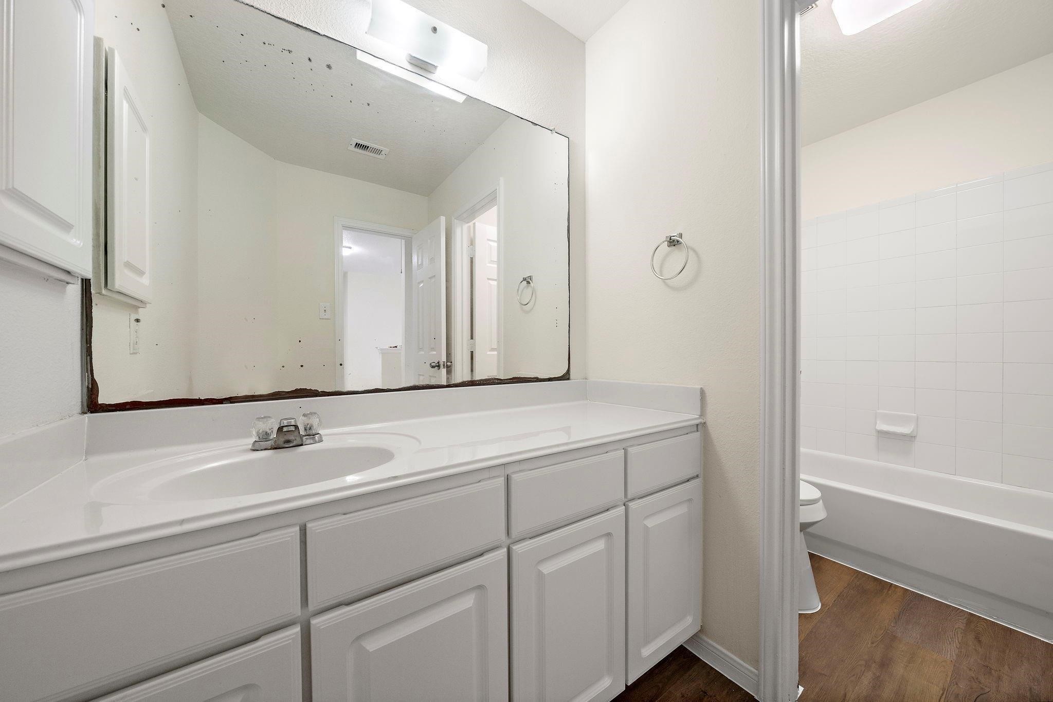 3235 Clipper Winds Way Houston, TX 77084 - Photo 5 of 26 a bathroom with a sink and a mirror