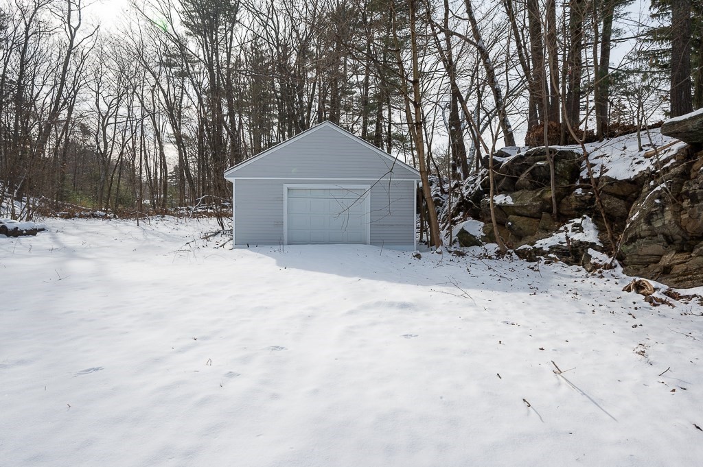 137 Fairview Park Road Sturbridge, MA 01566 - Photo 25 of 31 a front view of a house with a yard covered with snow