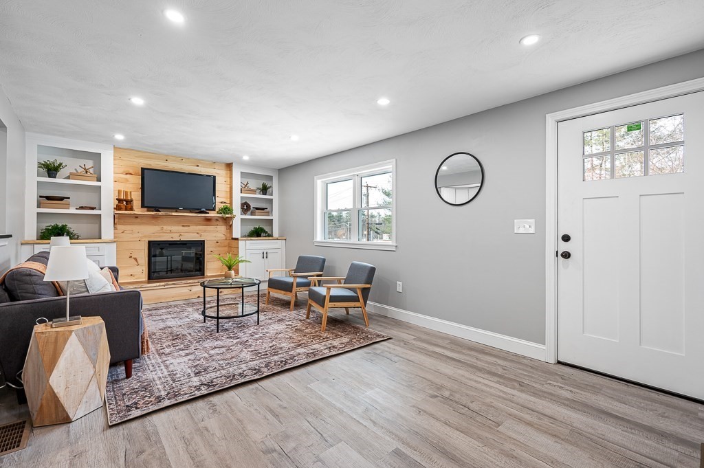 137 Fairview Park Road Sturbridge, MA 01566 - Photo 3 of 31 a living room with furniture a fireplace and a flat screen tv