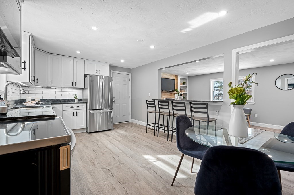 137 Fairview Park Road Sturbridge, MA 01566 - Photo 6 of 31 a kitchen with a table chairs refrigerator and microwave