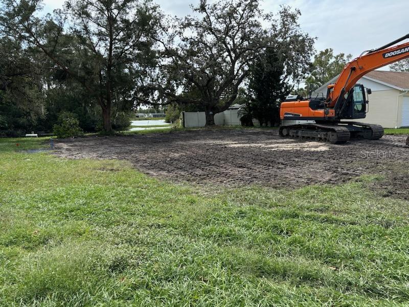 a backyard of a house with barbeque oven table and chairs