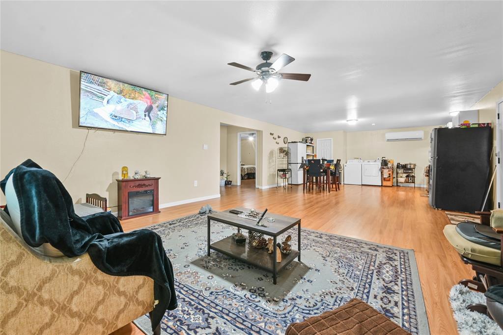 447 Masthead Road Gun Barrel City, TX 75156 - Photo 17 of 27 a living room with furniture and a flat screen tv with kitchen view