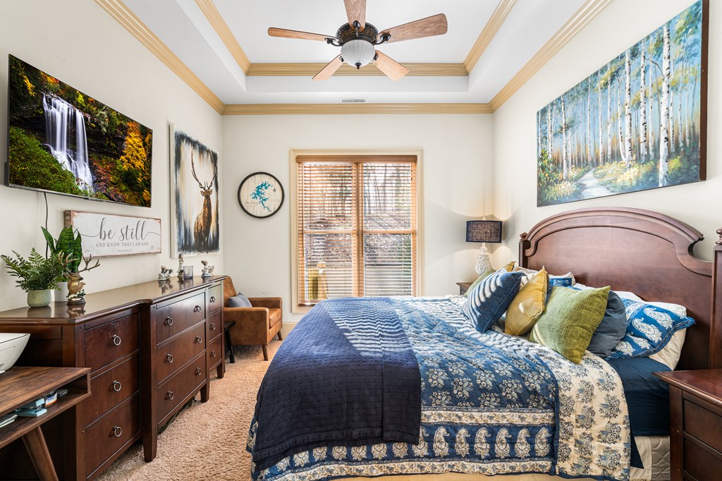 476 Licklog Ridge Hayesville, NC 28904 - Photo 26 of 41 a bedroom with a bed and dresser with mirror