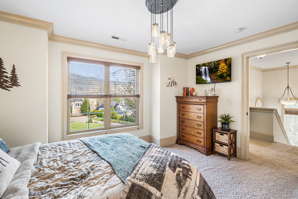 476 Licklog Ridge Hayesville, NC 28904 - Photo 38 of 41 a bedroom with a bed and a television