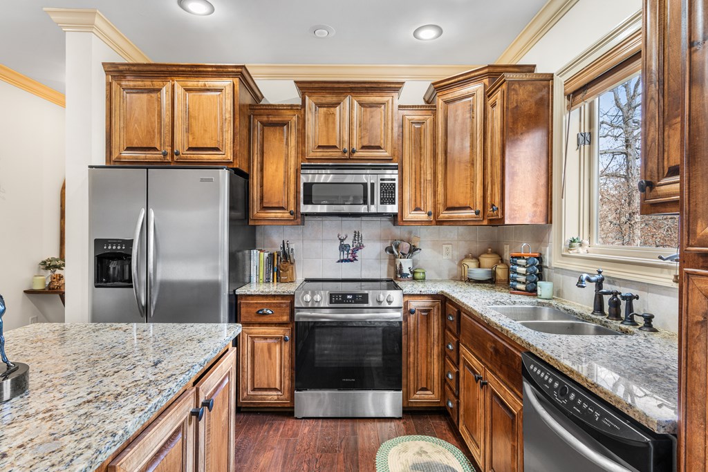 476 Licklog Ridge Hayesville, NC 28904 - Photo 10 of 41 a kitchen with stainless steel appliances granite countertop a stove a sink and a microwave