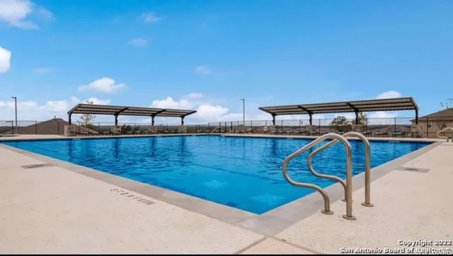 a view of a patio with a table and chairs under an umbrella