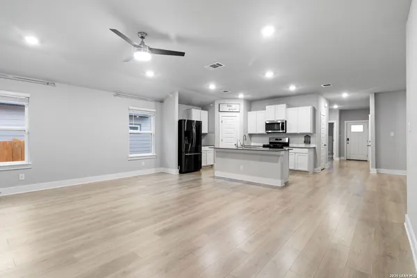 a kitchen with stainless steel appliances a sink and a refrigerator