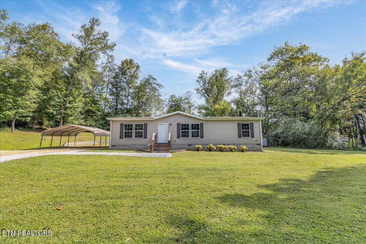 109 Post Oak Springs Road Rockwood, TN 37854 - Photo 1 of 24 a view of a house with a backyard