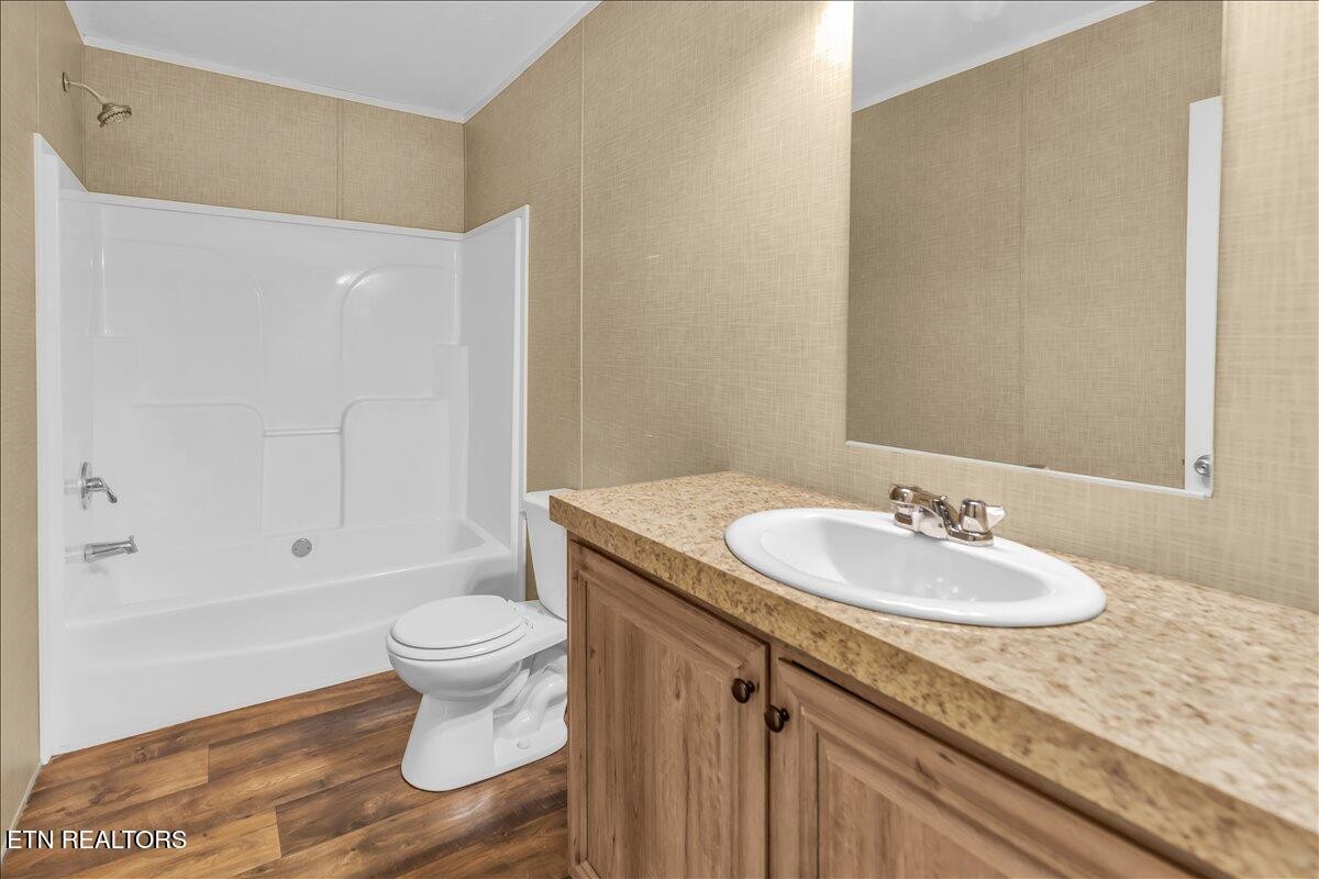 109 Post Oak Springs Road Rockwood, TN 37854 - Photo 15 of 24 a bathroom with a granite countertop sink toilet and a mirror