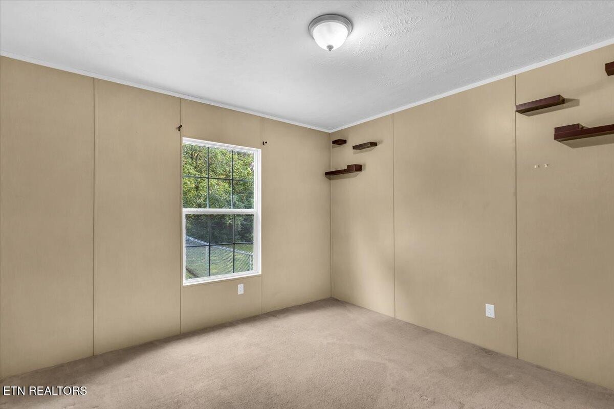 109 Post Oak Springs Road Rockwood, TN 37854 - Photo 18 of 24 a view of an empty room with a window