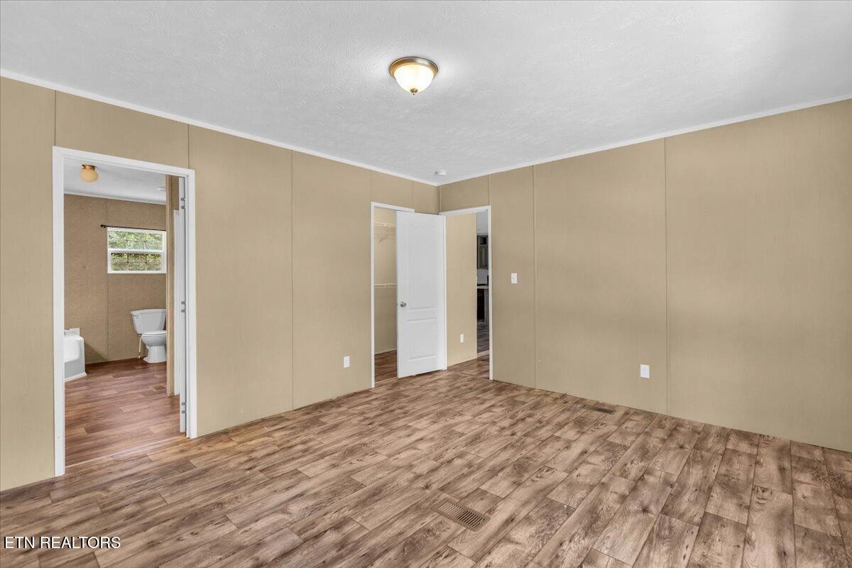 109 Post Oak Springs Road Rockwood, TN 37854 - Photo 23 of 24 a view of a room with wooden floor and bathroom