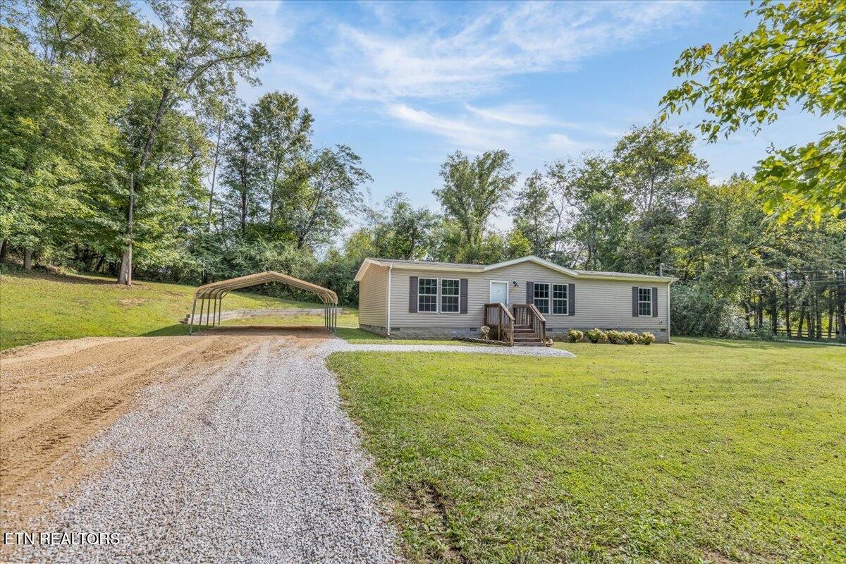 109 Post Oak Springs Road Rockwood, TN 37854 - Photo 3 of 24 a front view of a house with garden