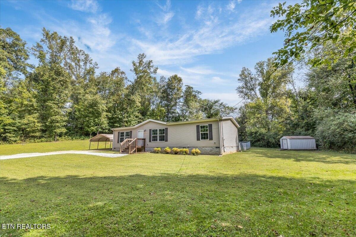109 Post Oak Springs Road Rockwood, TN 37854 - Photo 7 of 24 a view of a swimming pool with an outdoor space and seating area