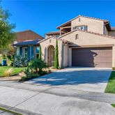 a view of white house with a yard and large tree