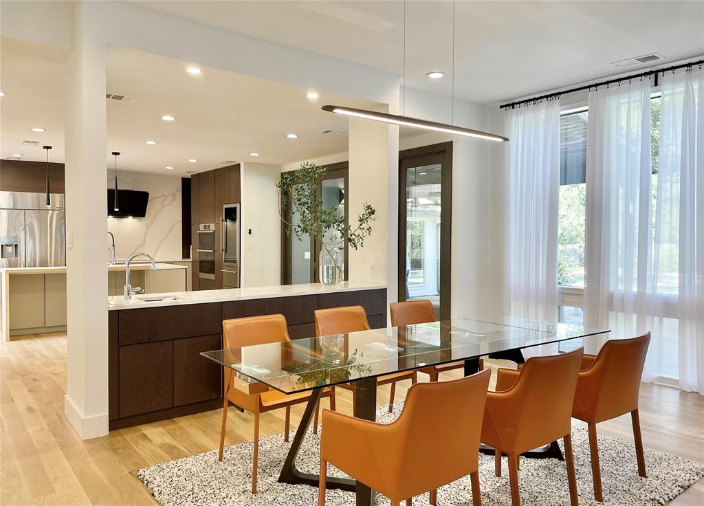 6802 Bert Lane Dallas, TX 75240 - Photo 13 of 38 a view of a dining room with furniture window and wooden floor
