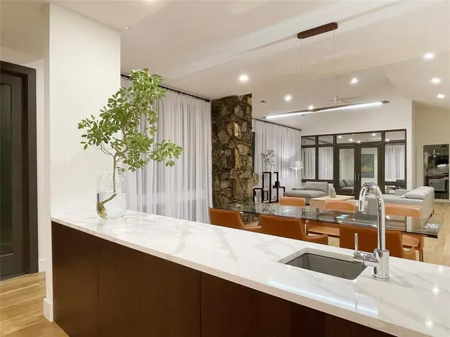 a kitchen with stainless steel appliances kitchen island granite countertop a sink and cabinets