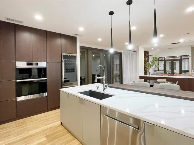 a view of a living room with a flat screen tv and refrigerator